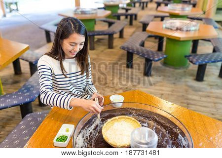 Woman enjoy japanese white noodles in restaurant