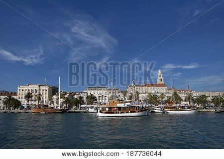 Split view on south part of old town behind sea and boats are Diocletian's palace and St Domnius cathedral