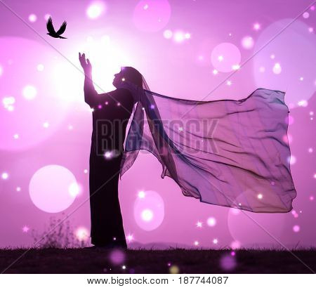  Copy space of silhouette woman rising hands on sunset sky double exposure colorful bokeh and bird fly background. Vintage tone filter effect color style.