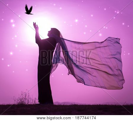  Copy space of silhouette woman rising hands on sunset sky double exposure colorful bokeh and bird fly background. Vintage tone filter effect color style.