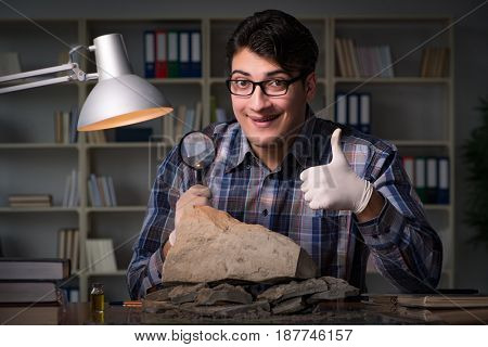 Archeologist working late night in office