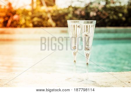 Two Glasses Of Prosecco  Cocktail With Blueberries At The Edge Of A Resort Pool. Concept Of Luxury V