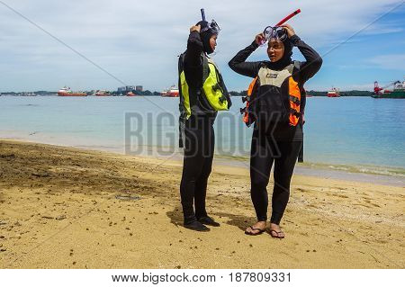 Labuan,Malaysia-Feb 19,2017:Young woman with life jacket & snorkel gear,ready to having fun doing snorkel watersport activity in Papan island of Labuan,Malaysia.