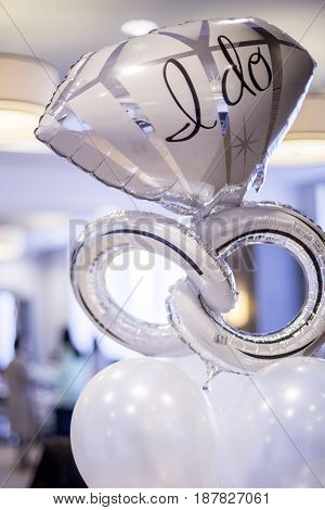 White and silver mylar engagement balloon that says