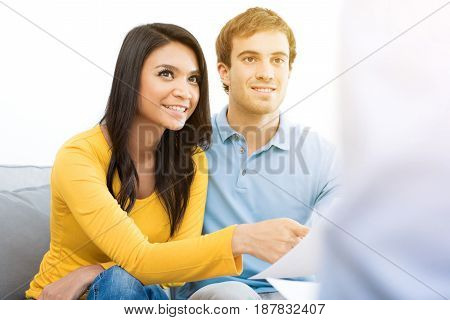 Young mixed race couple meeting with consultant (or counselor financial adviser real estate agent etc.)