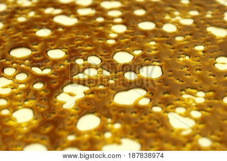 Close-up shot of highly pure and concentrated slab of shatter wax.