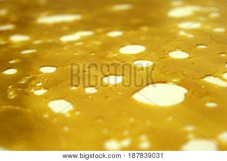 Close-up shot of highly pure and concentrated slab of shatter wax.