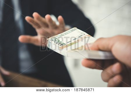 Businessman refusing money South Korean won bills - anti bribery and corruption concepts