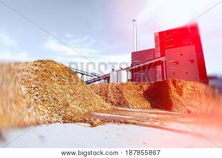 Bio Power Plant With Storage Of Wooden Fuel Against Blue Sky. Toned Image. Motion Blur Effect.