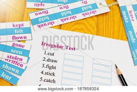 English test on table with pencil and cards
