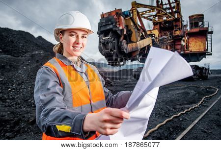 coal mining worker with excavator on the background