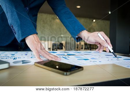 Close up of hand businessman working plan the business and analysis many chart graph. business concept.