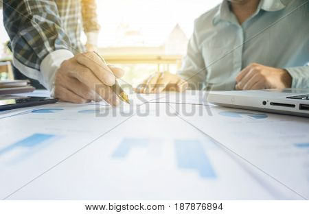 Two businessmen looking at report and having a discussion in office. business concept.