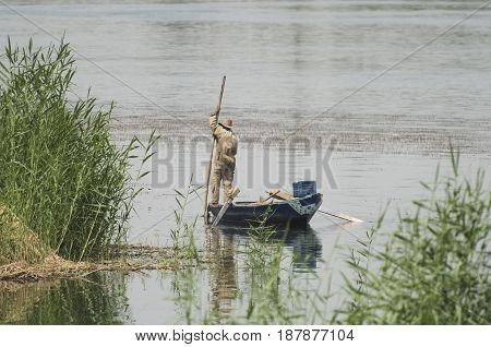 Traditional Egyptian Bedouin Fisherman On River By Reeds