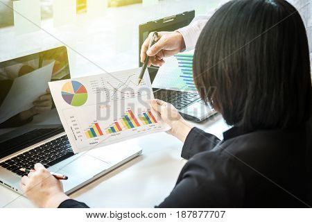 Two businessteam looking at report and having a discussion in office. business concept.
