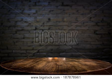 Selected focus empty brown wooden table and wall texture or old black brick wall blur background image. for your photomontage or product display