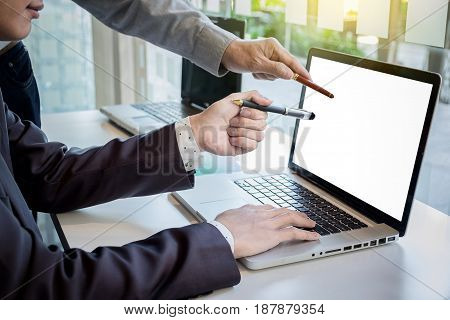 Two businessmen looking at report and having a discussion in office. business concept.