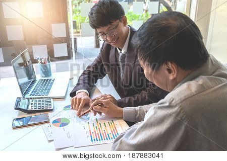 Business team two colleagues discussing working with many document graph in team Meeting Talking Brainstorming Communication Concept.