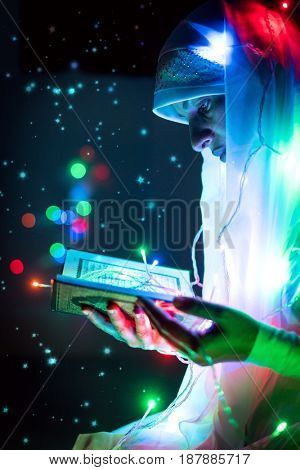 Muslim man praying for god in dark room at ramadan,colorful and vintage tone filter effect color style