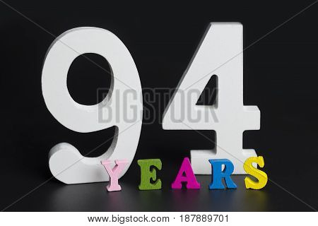 Letters And Numbers Ninety-four Years On A Black Background.