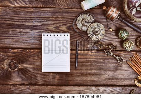 Empty paper notebook and Tibetan religious musical instruments for alternative medicine