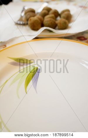 white dish with ascolana olives or fried stuffed olives at ascolana style