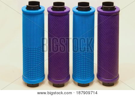 Colored bicycle grips close-up on a light background.