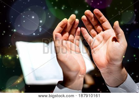 Muslim man hands holding rosary with quraan