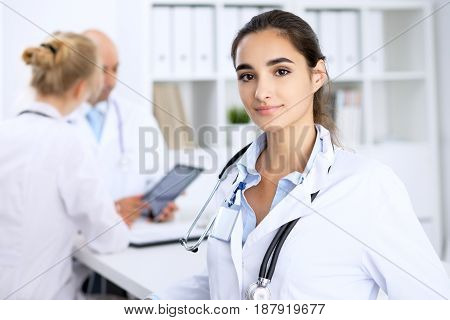 Happy doctor woman with medical staff at the hospital.