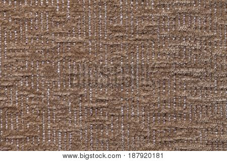 Dark brown fluffy background of soft fleecy cloth. Texture of bronze plush furry textile closeup.