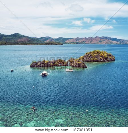 Aerial view of small islands with boats in Coron Bay. Palawan May 2017