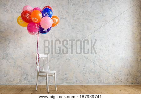 Chair and balloons on the wooden floor