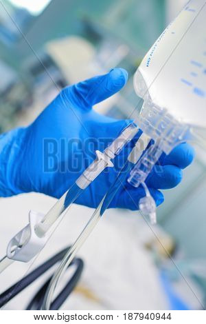 Doctor checks up the intravenous drip system.