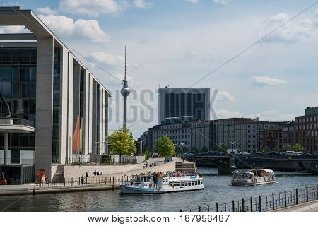 Berlin Germany - may 23 2017: Tourist boats on river Spree at government district with tv tower background in Berlin Germany.