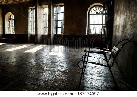 wooden chair in grungy interior. Loneliness estrangement alienation concept.