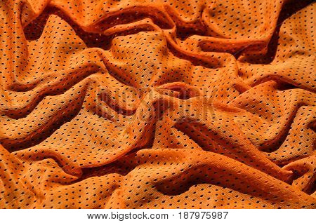 Sport Clothing Fabric Texture Background. Top View Of Orange Polyester Nylon Cloth Textile Surface.