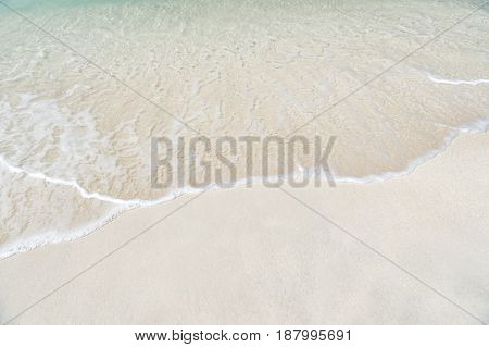 Beautiful marine view on ?aribbean sea coast line with clean wavy surf ocean water on sandy beach in st. john Antigua at sunny day as natural background