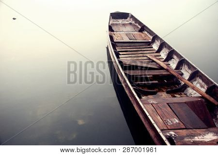 The Wooden Boat Was Resting In The River Calmly.