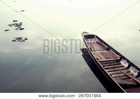 The Wooden Boat Was Resting In The River Calmly.