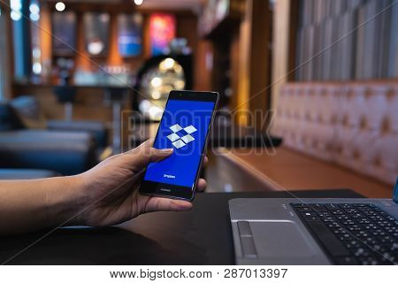 Chiang Mai, Thailand - May 05,2018: Man Holding Huawei With Dropbox On Screen. Dropbox Is A Service 