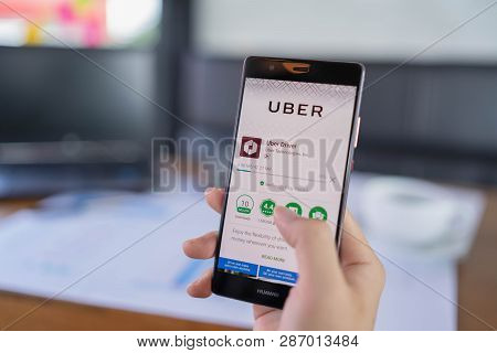Chiang Mai, Thailand - May 05,2018: Man  Holding Huawei With Uber Apps. Uber Is Smartphone App Trans