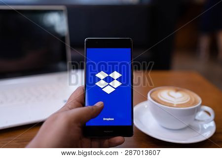 Chiang Mai, Thailand - May 19,2018: Man Holding Huawei With Dropbox On Screen. Dropbox Is A Service 