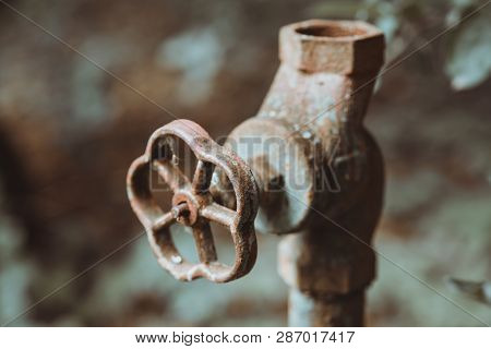 Old Worn Out Water Pipes. Broken Hydraulic Valve, Crane. Old Pipes Of Heating. Torn Conduits. Large 