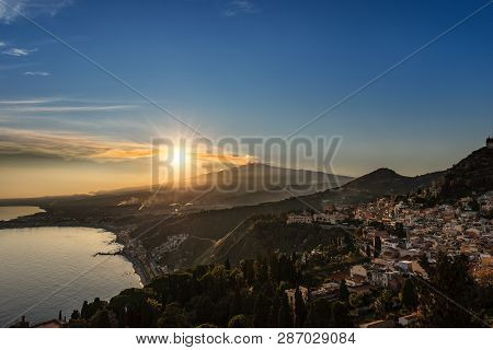 Mount Etna Volcano With Smoke And The Taormina Town, Messina, Sicily Island, Italy, Europe