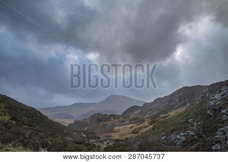 Dark And Dramatic Winter Landscape Image Of Moel Saibod From Crimpiau In Snowdonia With Stunning Sha