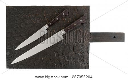 Long and short knives on wooden board shot from above, isolated on white