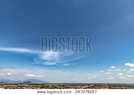 Ipoh, Malaysian Cityscape At The Early Morning With Twirly Cloud And Blue Sky