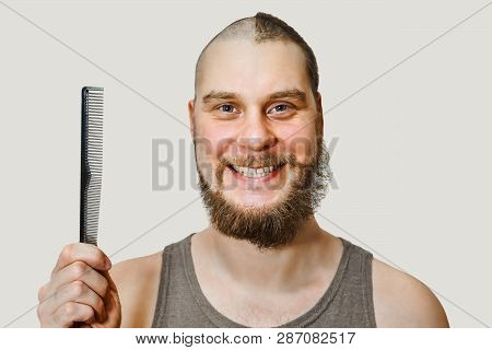 Half Trimmed Guy: On The One Hand Bald, On The Other With Hair On Gray Background. Man Combing Comb.