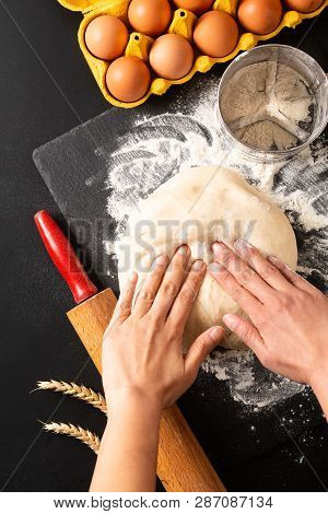 Food Preparation Concept Over Head Shot Kneading Dough For Bakery, Pizza Or Pasta On Black Backgroun