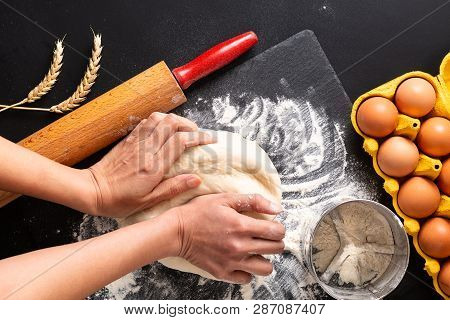 Food Preparation Concept Over Head Shot Kneading Dough For Bakery, Pizza Or Pasta On Black Backgroun